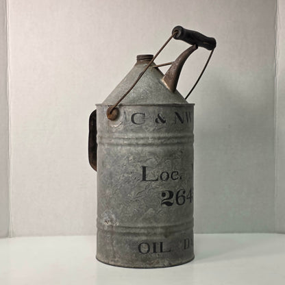 Antique galvanized oil can with classic railroad-inspired industrial character.