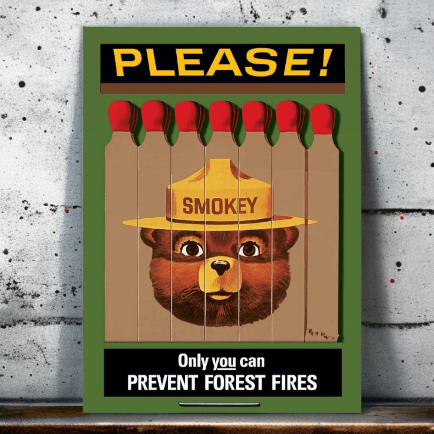 Smokey Bear poster with matches on a textured wall background