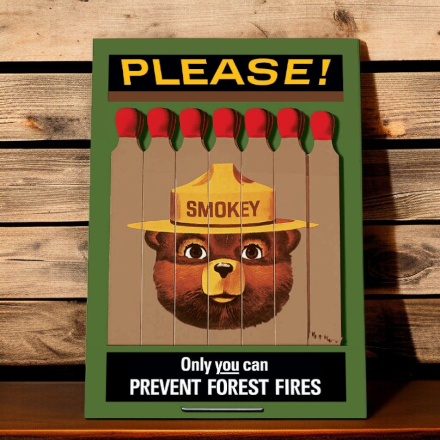 Smokey Bear poster with matches on a wooden background