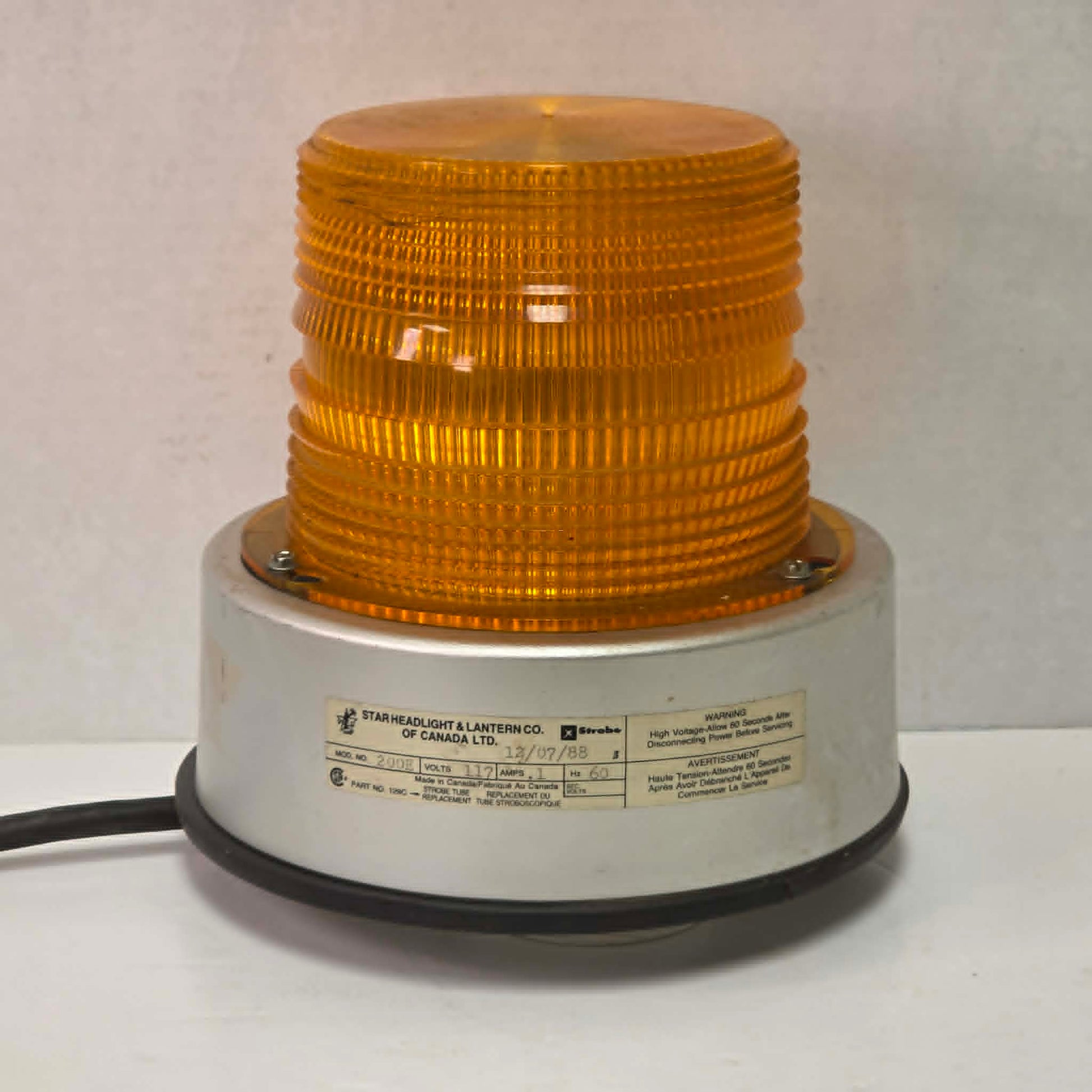 Vintage amber railroad strobe beacon light Star Headlight Model 200E industrial safety lamp with 360 degree flash and threaded base mount.