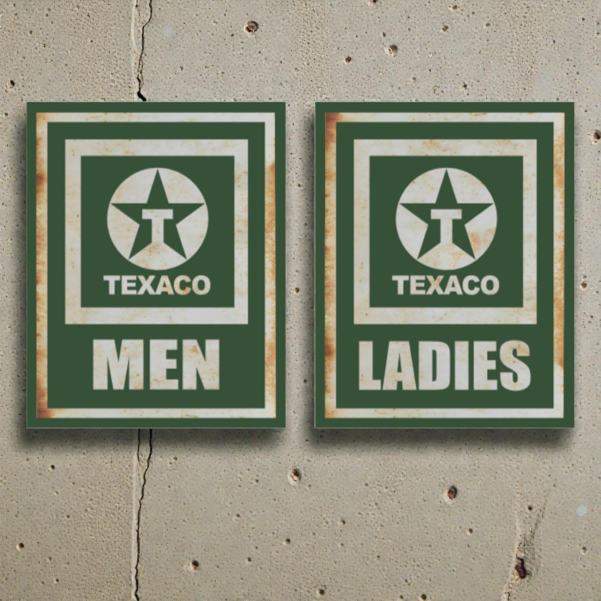 Two vintage-style Texaco restroom signs on a concrete wall.