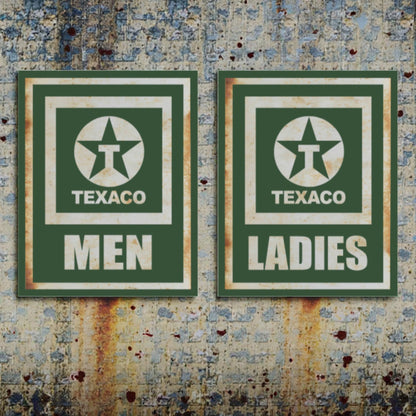 Two vintage Texaco restroom signs on a textured wall.