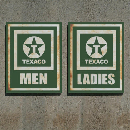 Two vintage-style Texaco restroom signs on a textured wall.