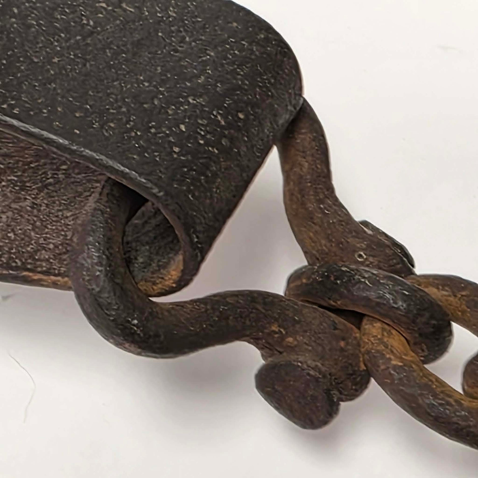 Antique Triumph 415X bear trap with toothed jaws and attached chain.
