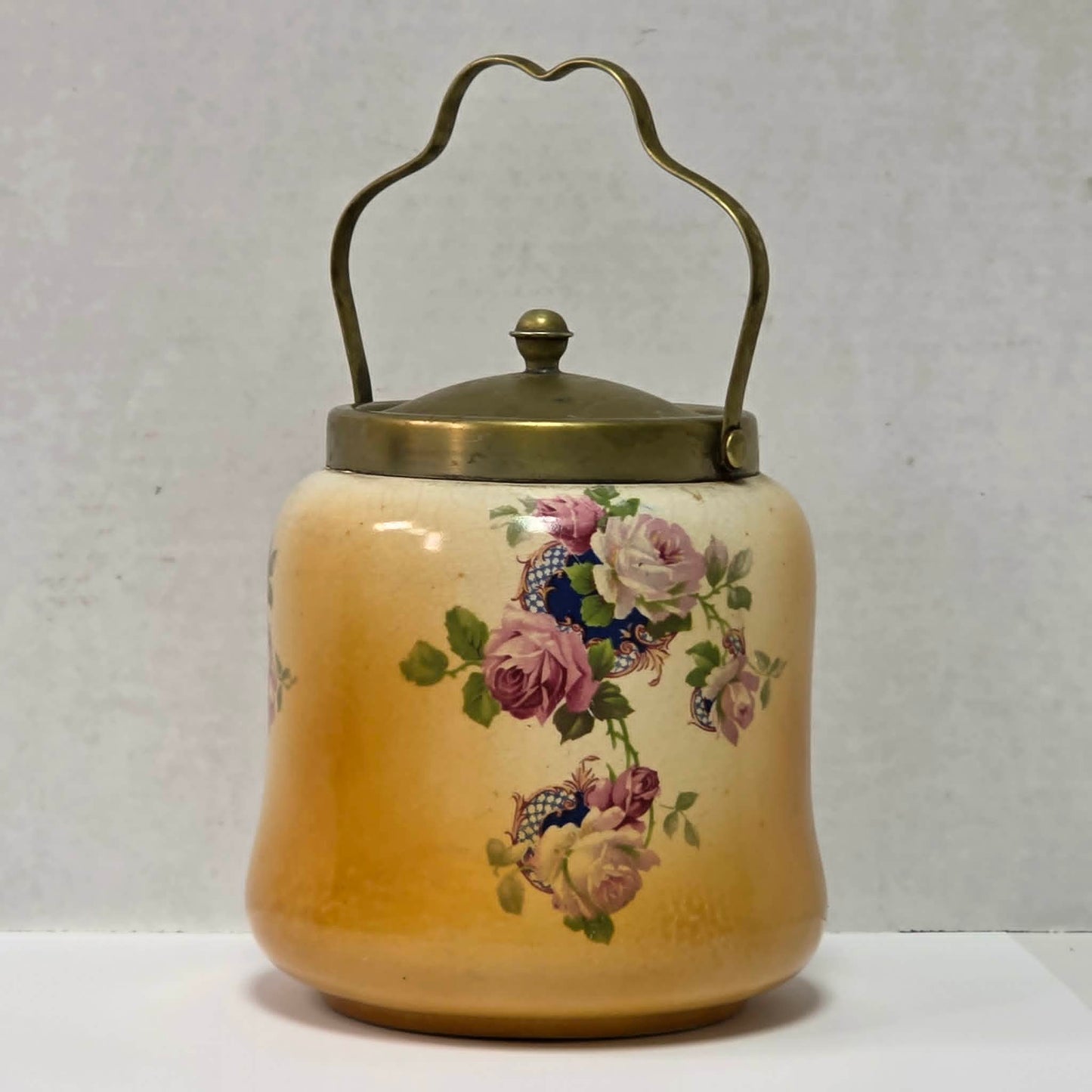 Victorian porcelain biscuit barrel with beautiful rose motif and antique crazing.
