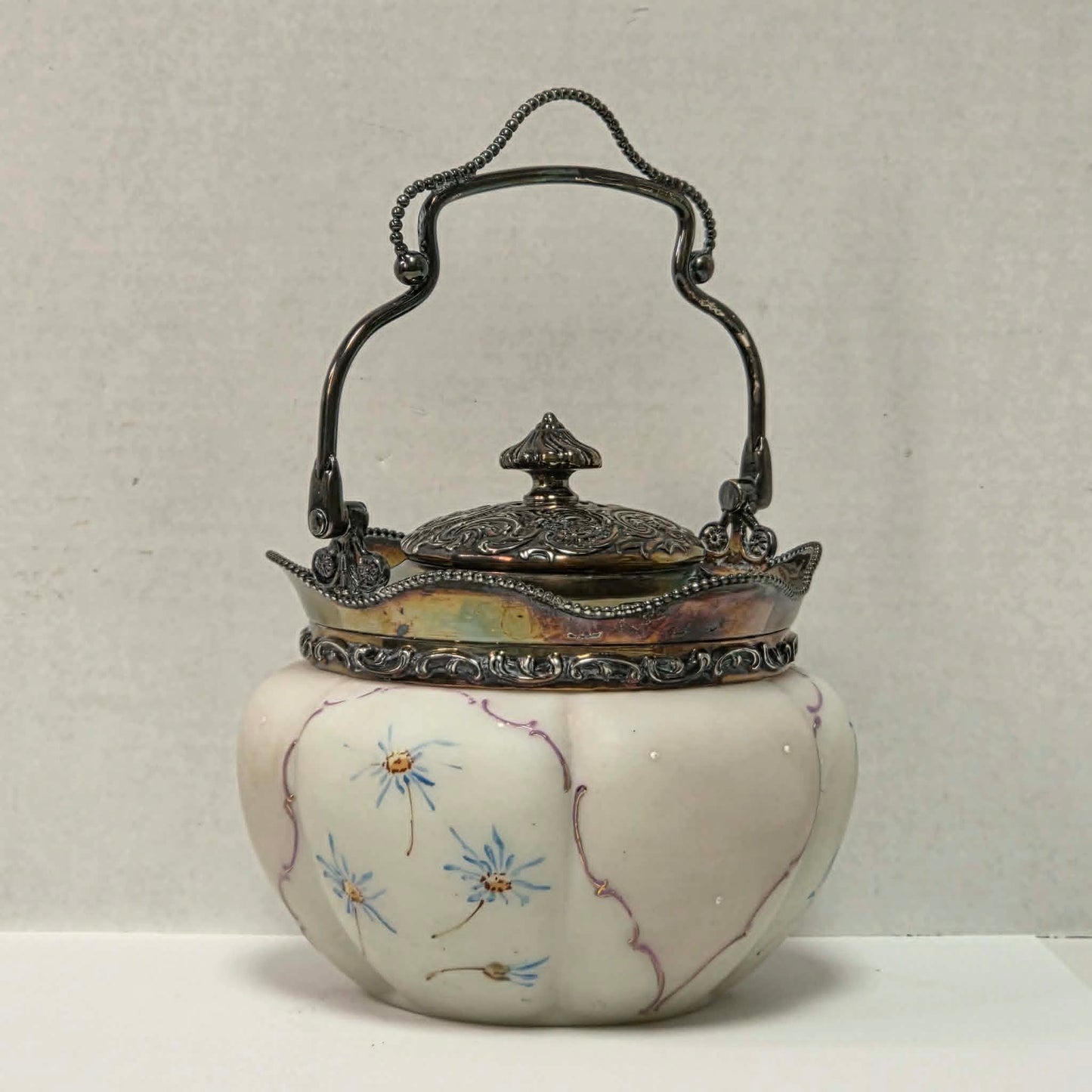 Victorian Mount Washington biscuit barrel with pastel pink and blue floral glass and ornate handle.
