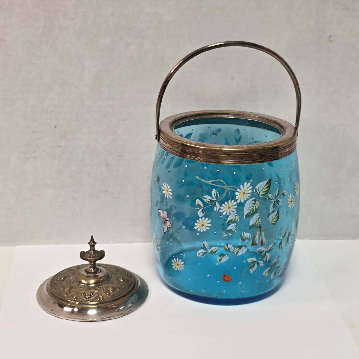 Victorian pastel blue glass biscuit barrel with hand-painted flowers, butterflies and bees.

