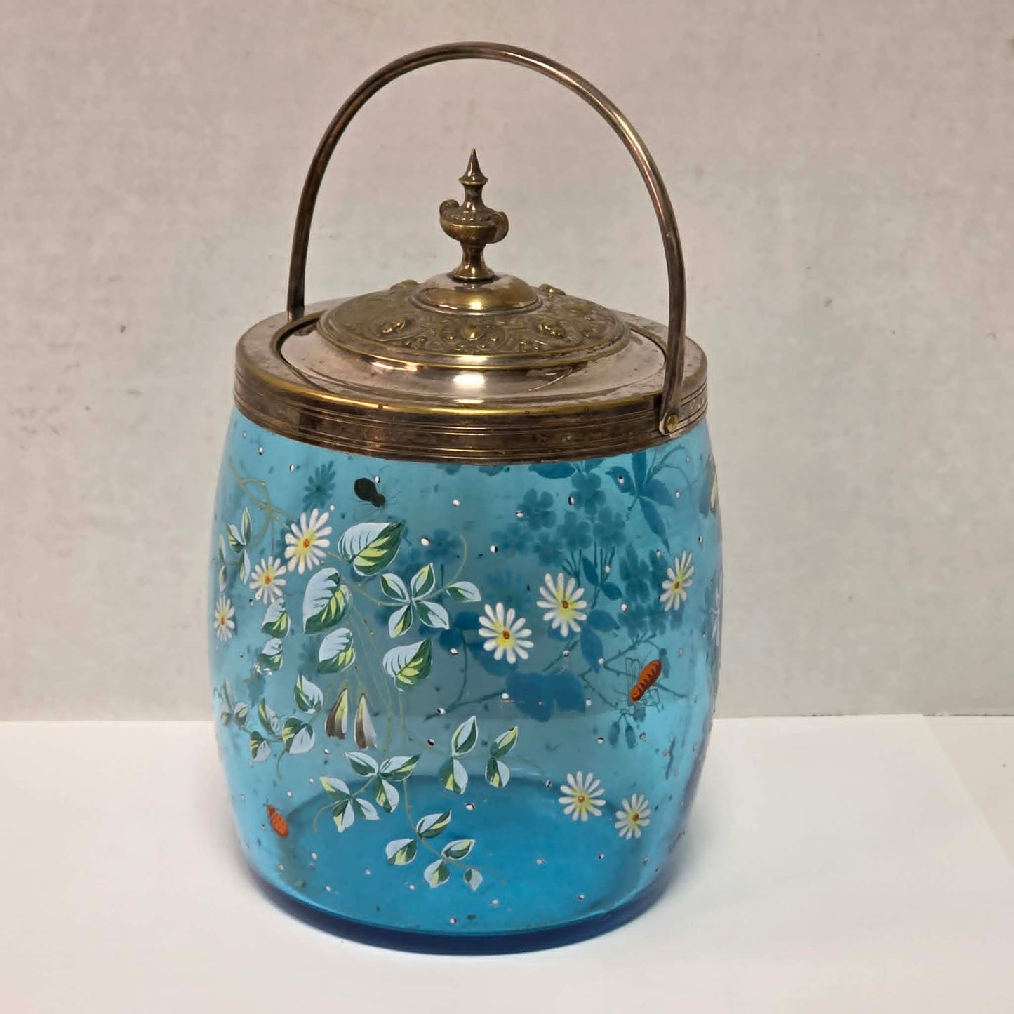 Victorian pastel blue glass biscuit barrel with hand-painted flowers, butterflies and bees.
