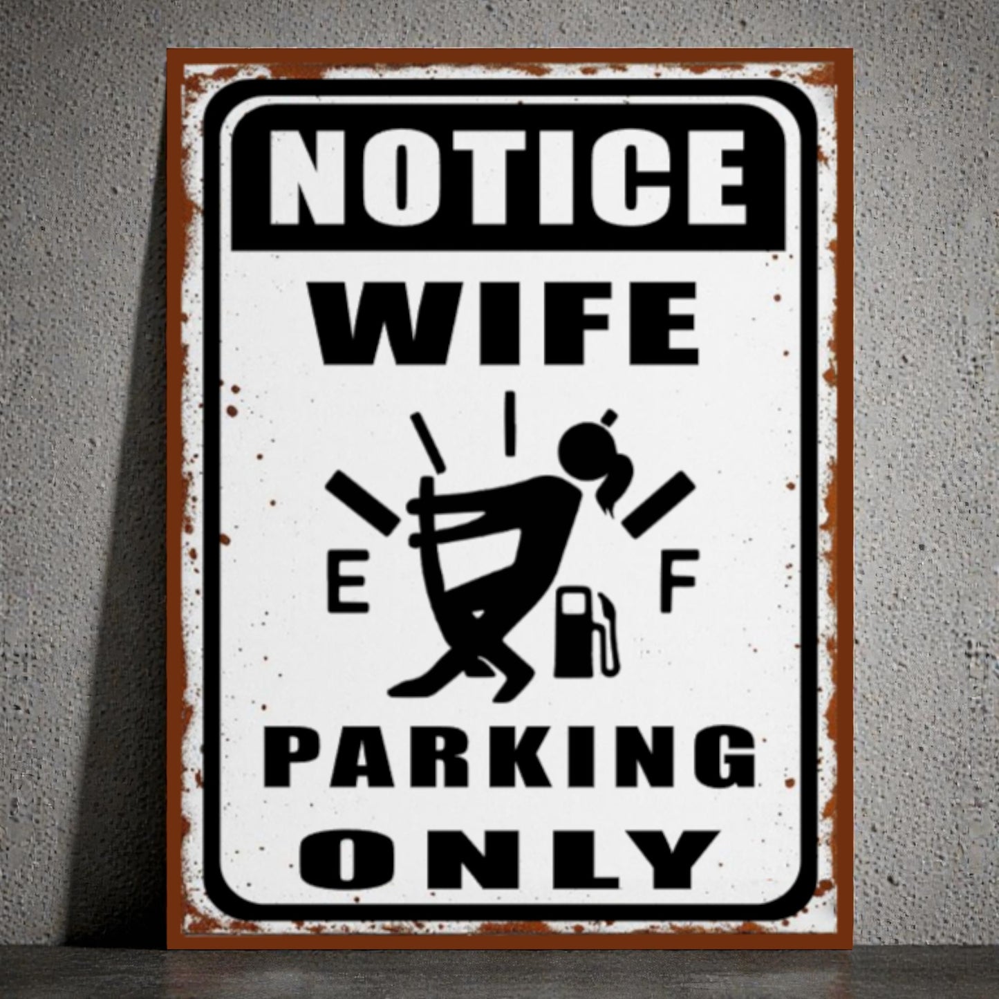 Metal sign with humorous design of a woman and text 'Notice Wife Parking Only' on a gray background