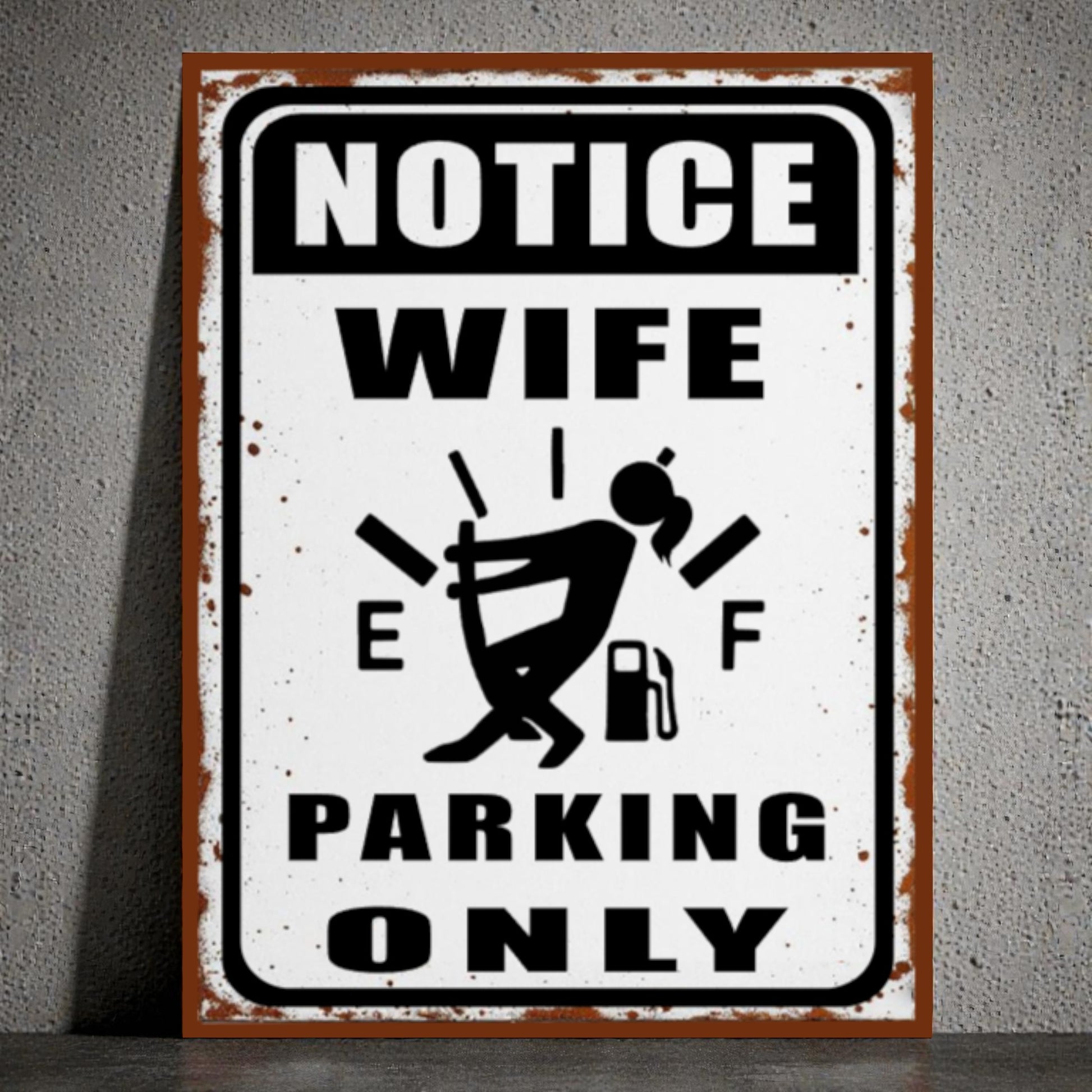 Metal sign with humorous design of a woman and text 'Notice Wife Parking Only' on a gray background
