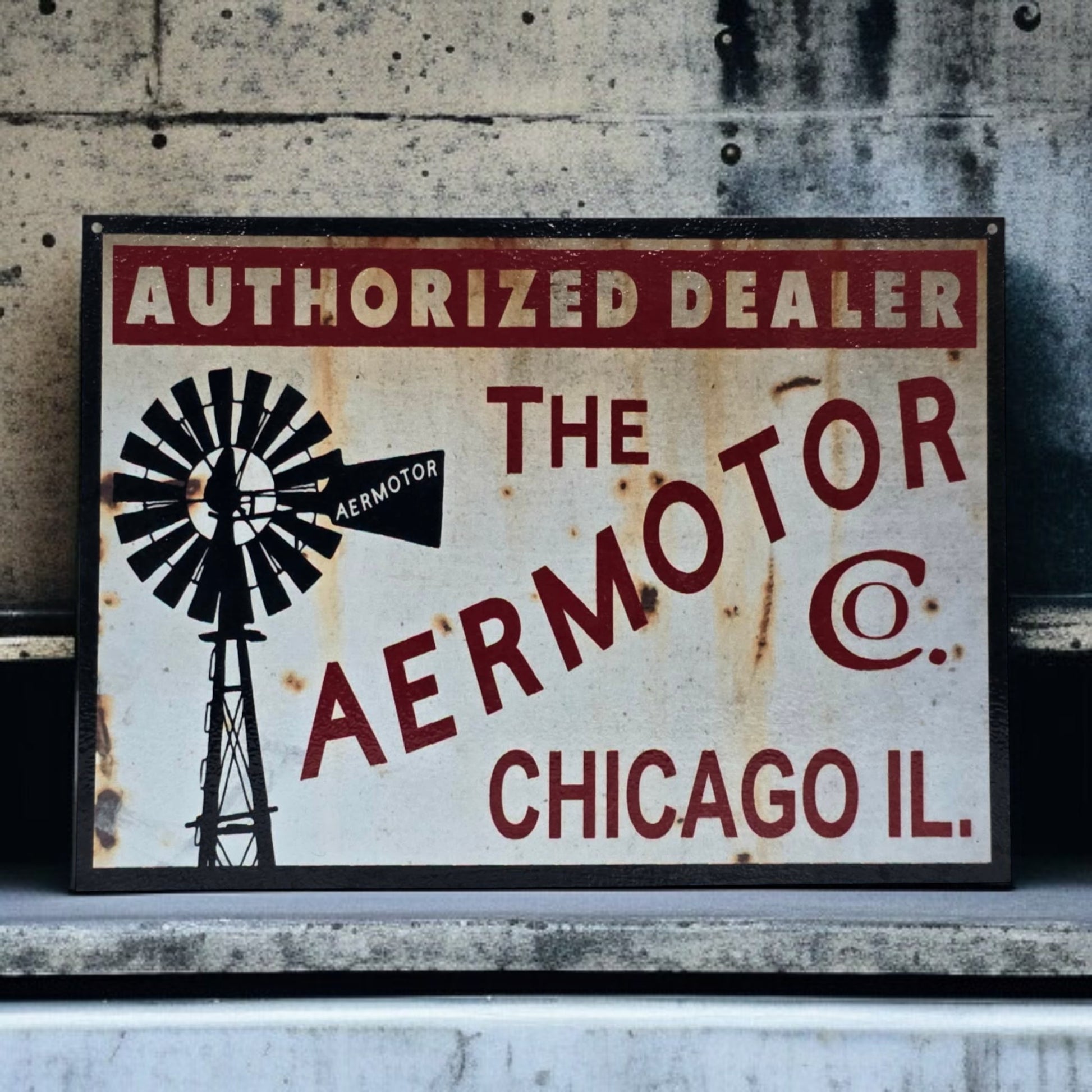 Vintage-style sign for Aermotor Co. with windmill graphic on a textured wall background