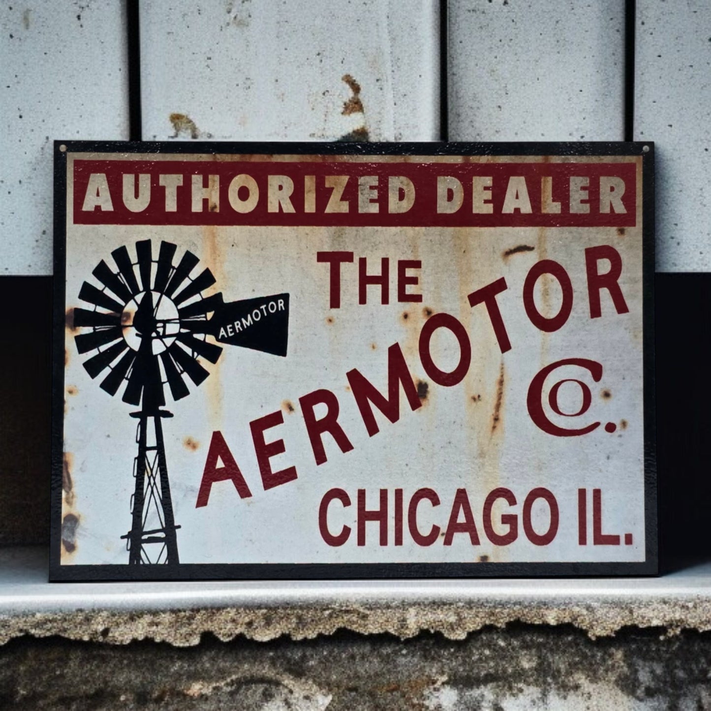 Vintage-style sign for Aermotor Co. with a windmill graphic on a rustic background.