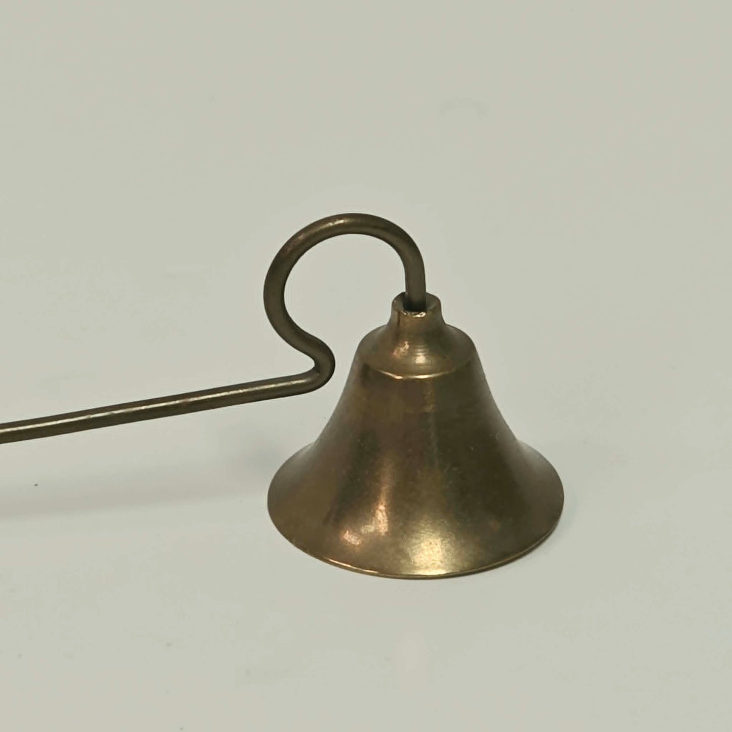Antique solid brass candle snuffer with threaded handle and original patina.
