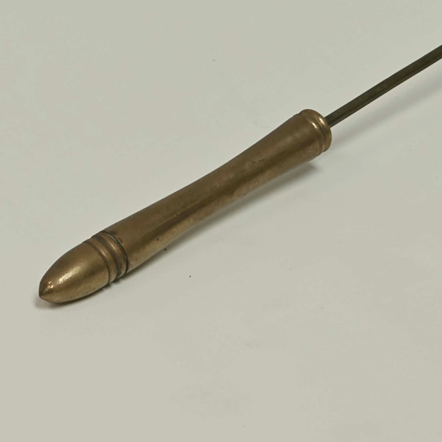Antique solid brass candle snuffer with threaded handle and original patina.

