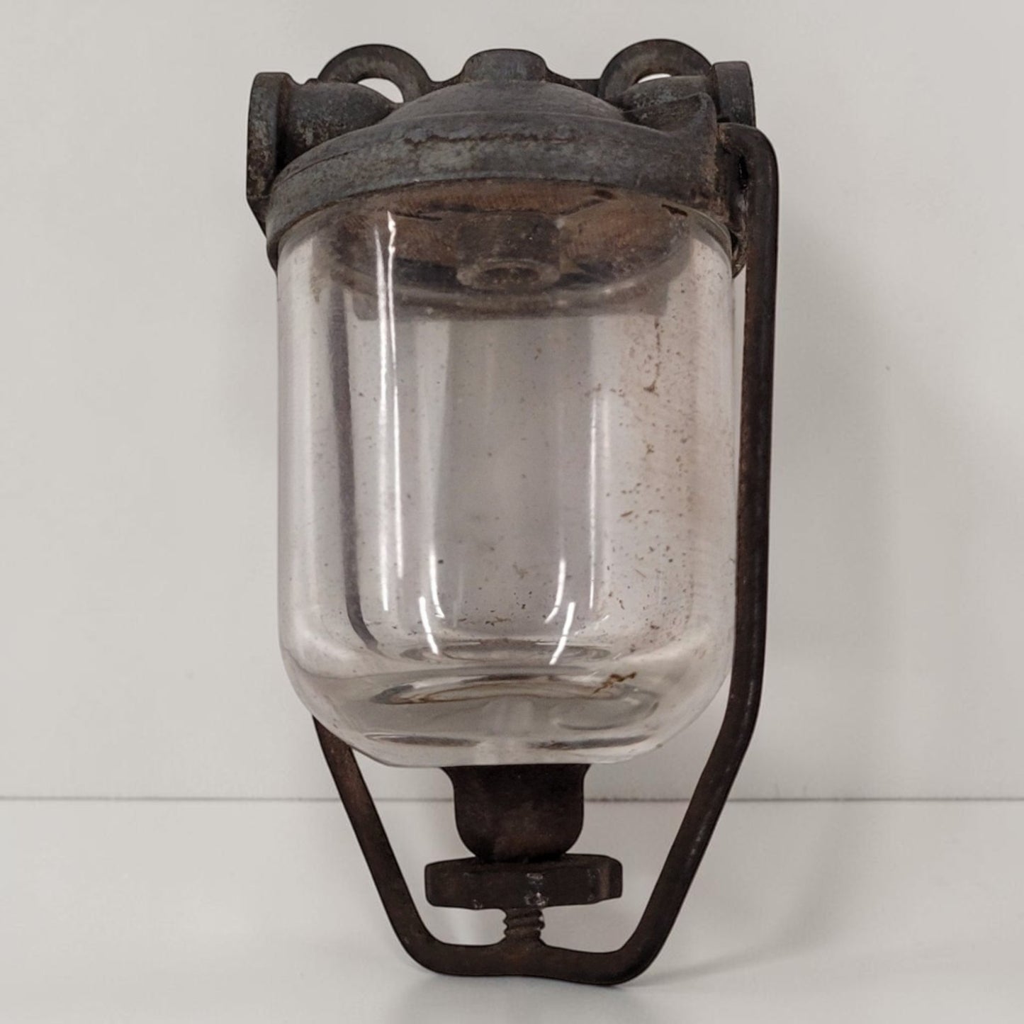Antique glass fuel sediment bowl used on tractors and hit and miss engines for filtering fuel and separating water and debris.