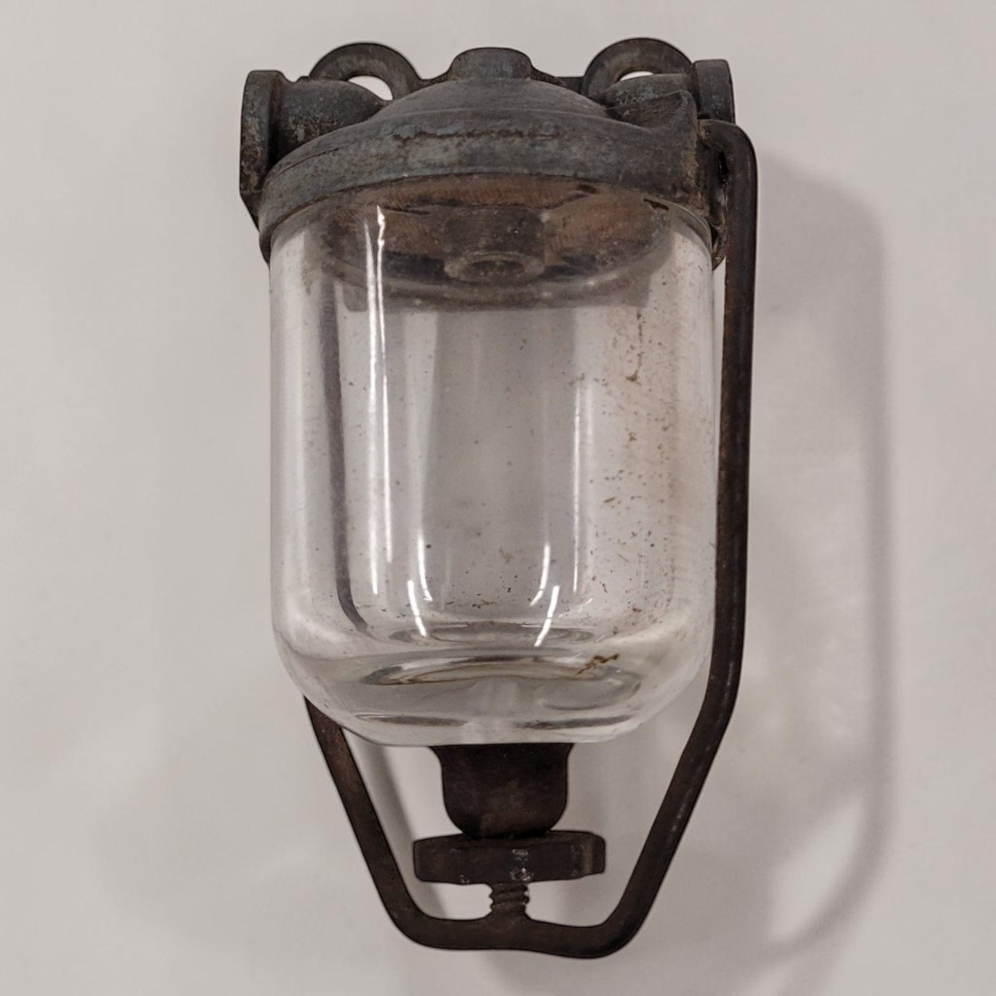 Antique glass fuel sediment bowl used on tractors and hit and miss engines for filtering fuel and separating water and debris.