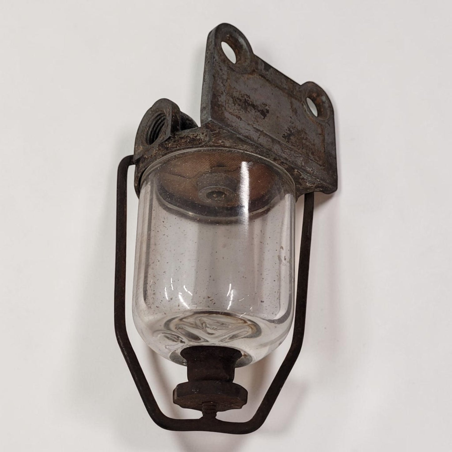 Antique glass fuel sediment bowl used on tractors and hit and miss engines for filtering fuel and separating water and debris.