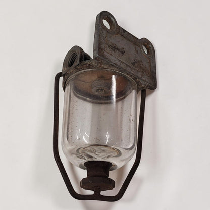 Antique glass fuel sediment bowl used on tractors and hit and miss engines for filtering fuel and separating water and debris.