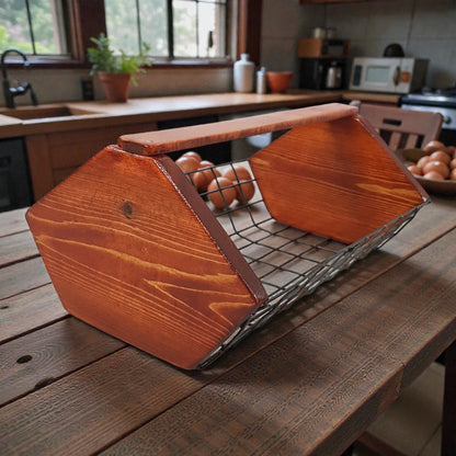 Wooden fruit basket with oranges on a wooden table in a kitchen.
