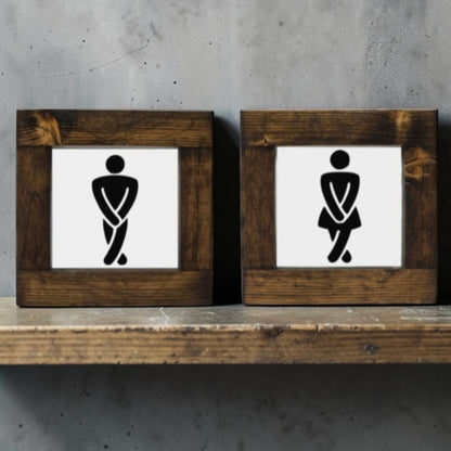 Handmade men's and women's bathroom signs with humorous crossing legs figures.
