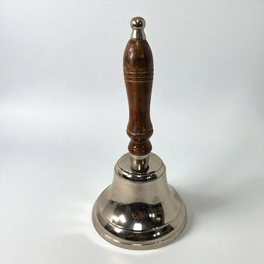 Silver bell with a wooden handle on a white background