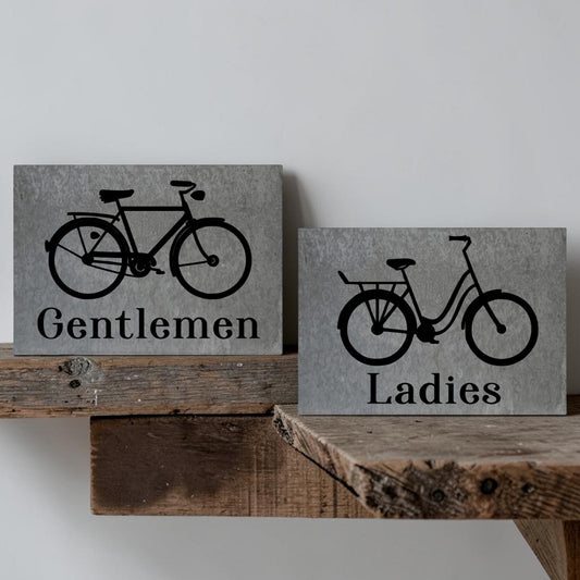 Ladies bicycle bathroom sign
Gentlemen bicycle bathroom sign
Barn tin restroom sign set
Antique bike wall decor sign
Rustic metal bathroom signage