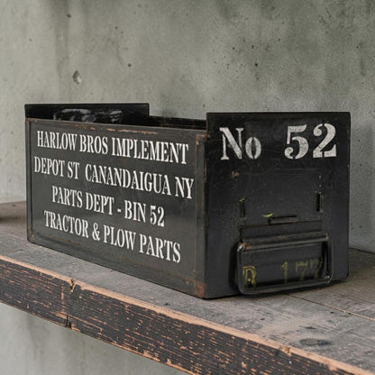 Vintage army green industrial metal parts bin with stenciled lettering and front label slot.
