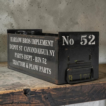 Vintage army green industrial metal parts bin with stenciled lettering and front label slot.
