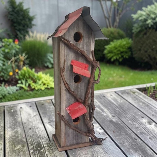 Handcrafted reclaimed cedar and barn tin birdhouse with three nesting spots.
