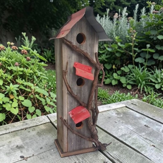 Handcrafted reclaimed cedar and barn tin birdhouse with three nesting spots.
