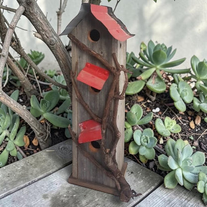 Handcrafted reclaimed cedar and barn tin birdhouse with three nesting spots.