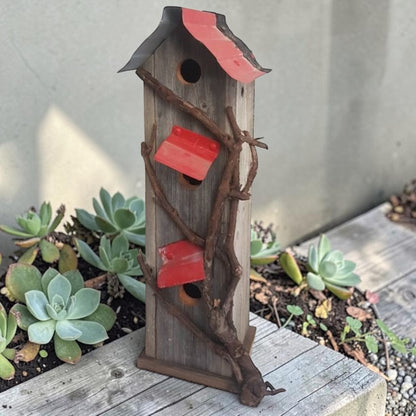 Handcrafted reclaimed cedar and barn tin birdhouse with three nesting spots.