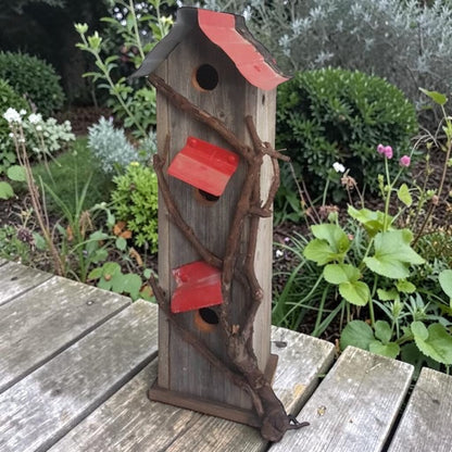Handcrafted reclaimed cedar and barn tin birdhouse with three nesting spots.