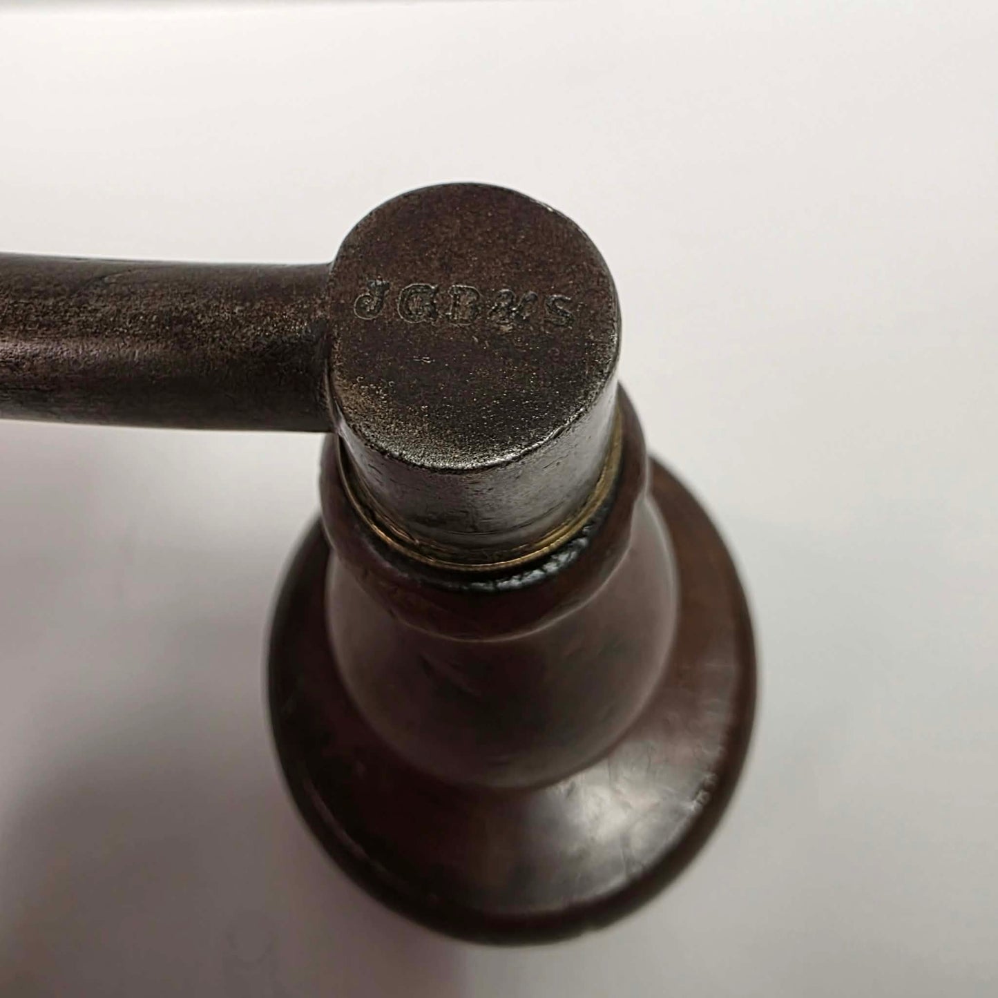 An exquisitely crafted antique walnut-handled bit brace that showcases the beauty and precision of early woodworking tools.
