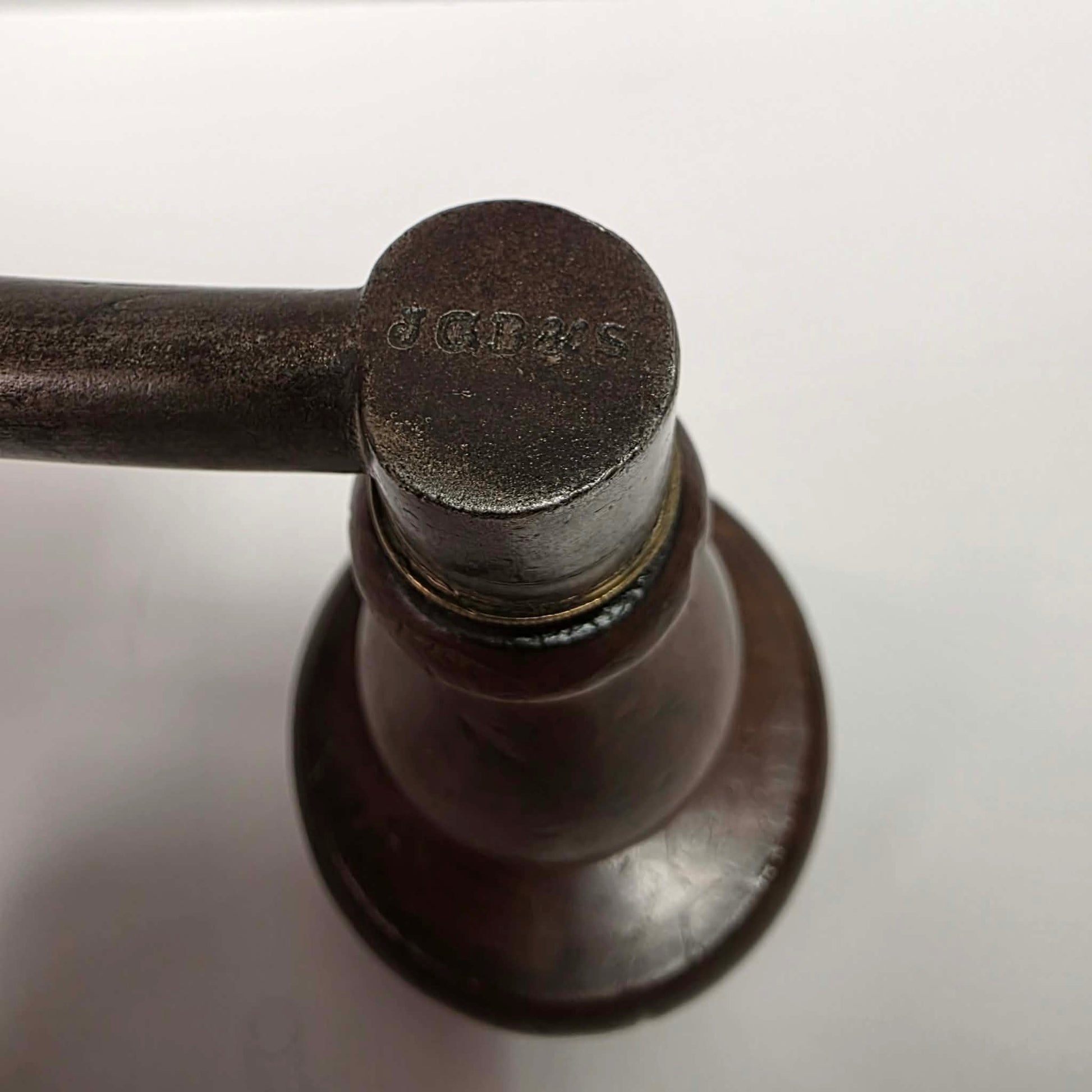 An exquisitely crafted antique walnut-handled bit brace that showcases the beauty and precision of early woodworking tools.
