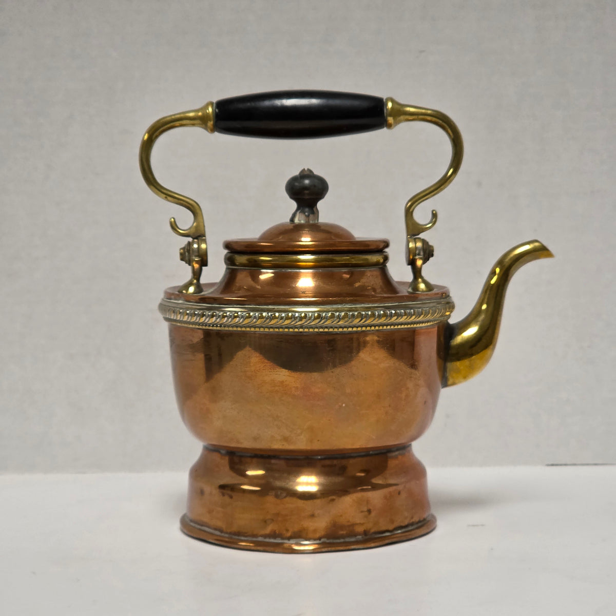 Ornate Victorian copper and brass teapot with ebonized handle
