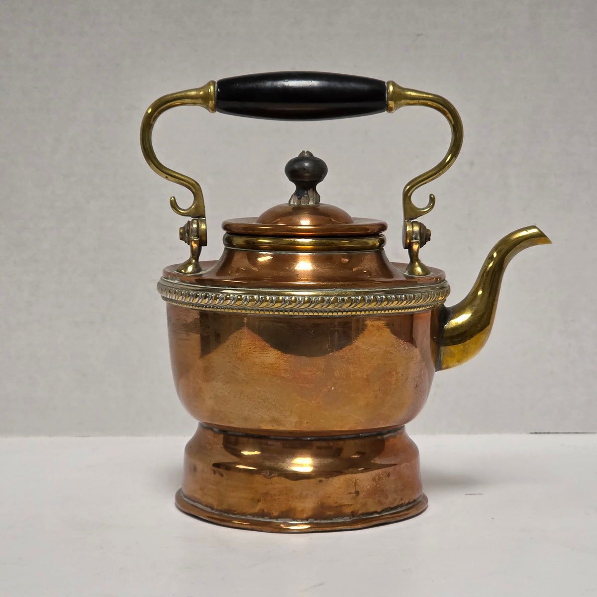 Ornate Victorian copper and brass teapot with ebonized handle
