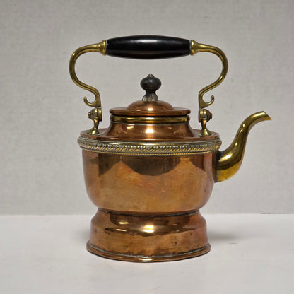 Ornate Victorian copper and brass teapot with ebonized handle
