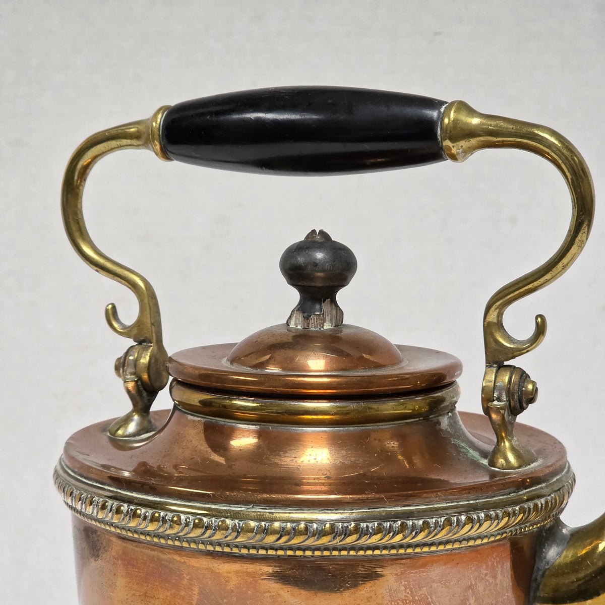 Ornate Victorian copper and brass teapot with ebonized handle
