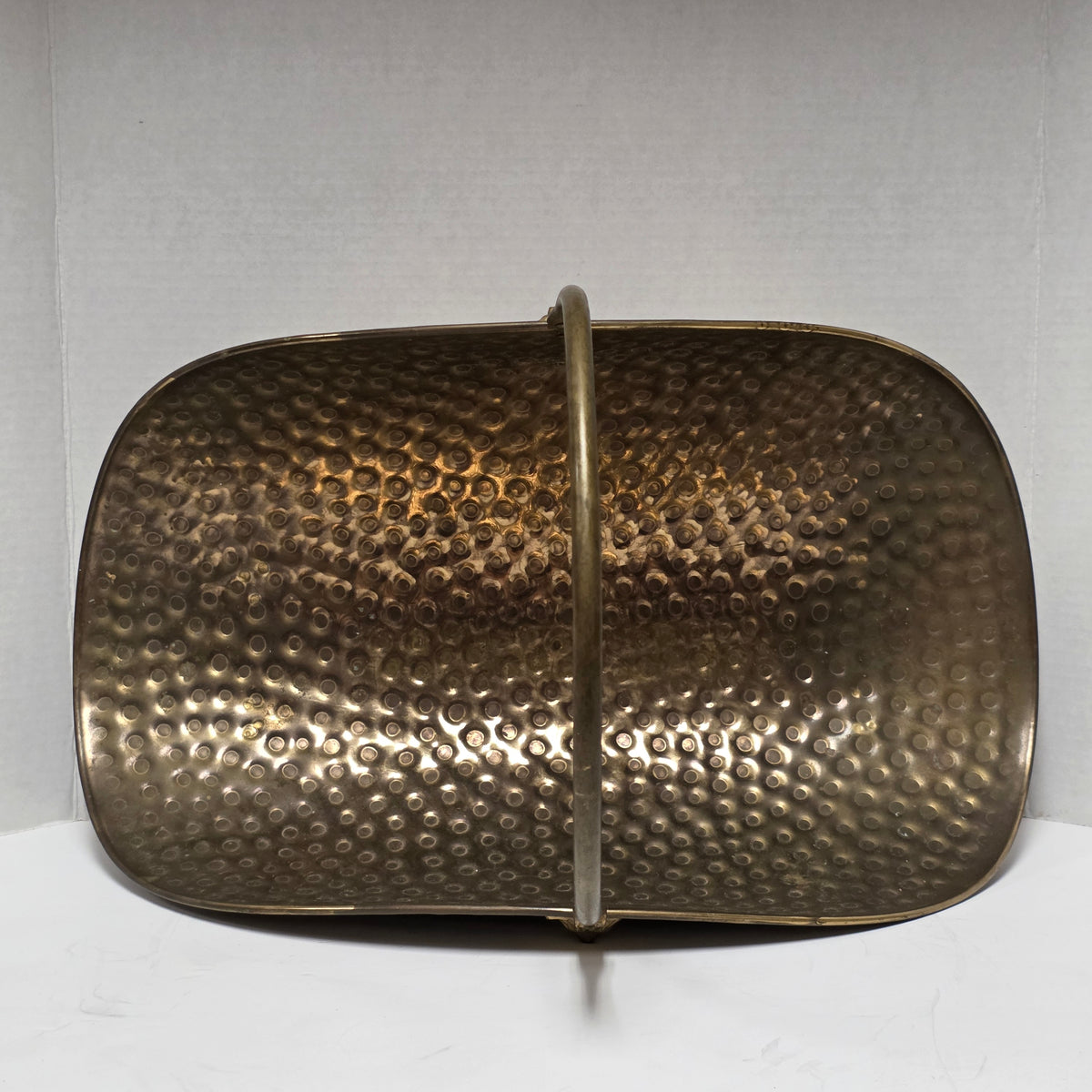 Ornate brass fireplace log holder with lion heads and paw feet
