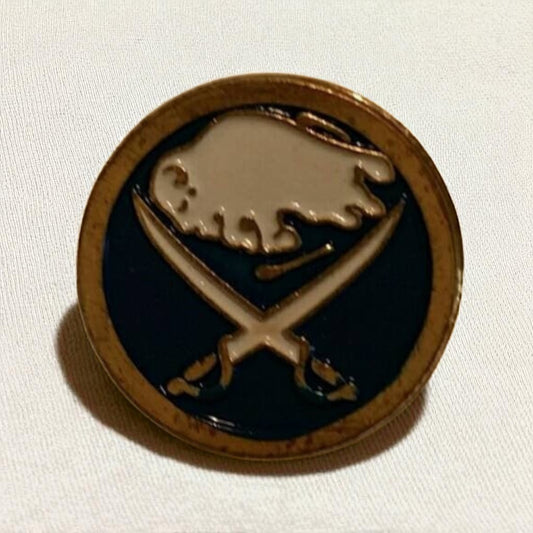 Round badge with a logo featuring a buffalo and crossed swords on a white background