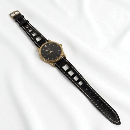 Black watch with gold case on a white background
