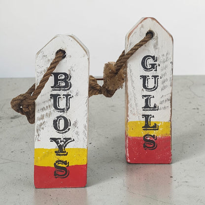 Hand-painted lobster buoy Boys and Girls bathroom signs made from reclaimed wood.
