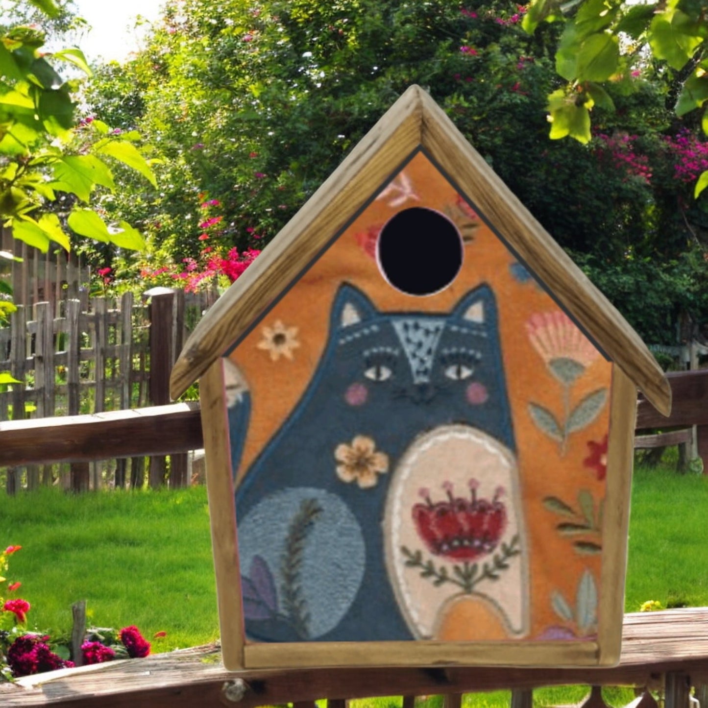 Decorative birdhouse with a fox design in an outdoor setting