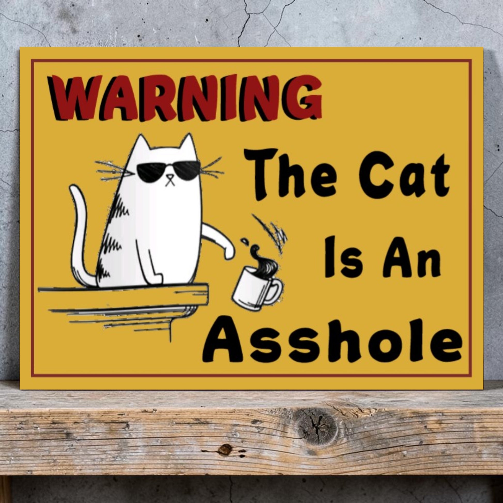 Funny handmade aluminum warning sign showing a cat pushing a coffee cup off a table.
