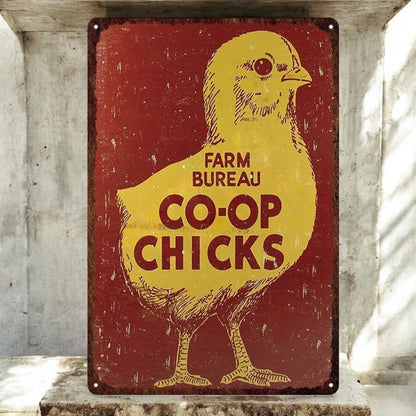 Vintage-style sign with a yellow chick illustration and text on a red background, placed against a concrete wall.
