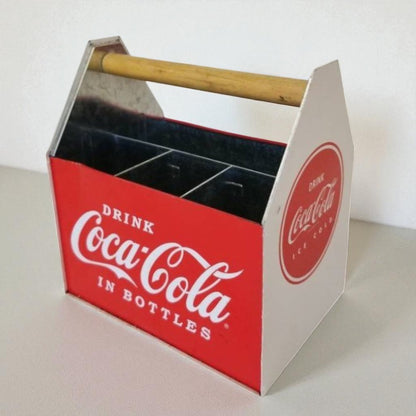 Coca-Cola bottle carrier with red and white design on a light background