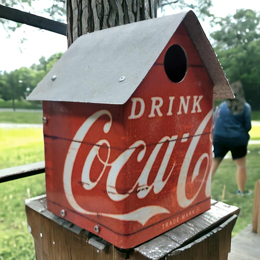 Handcrafted Coca-Cola birdhouse with reclaimed wood, galvanized roof, and Drink Coca-Cola metal walls.
