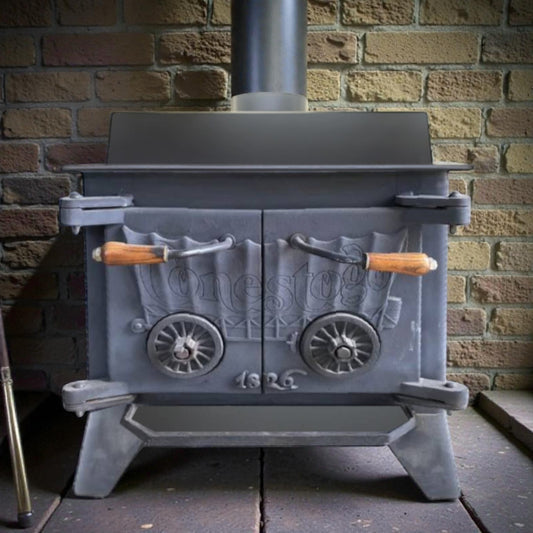 Conestogo cast iron stove with decorative elements against a brick wall.