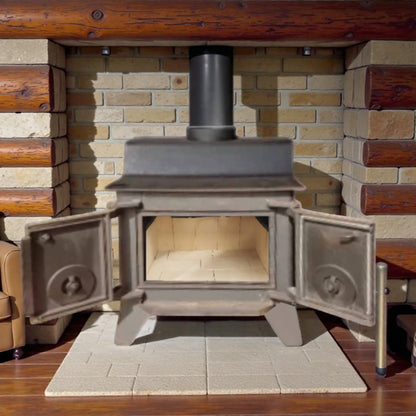 Wood-burning stove in a rustic setting with stone wall and wooden beams.